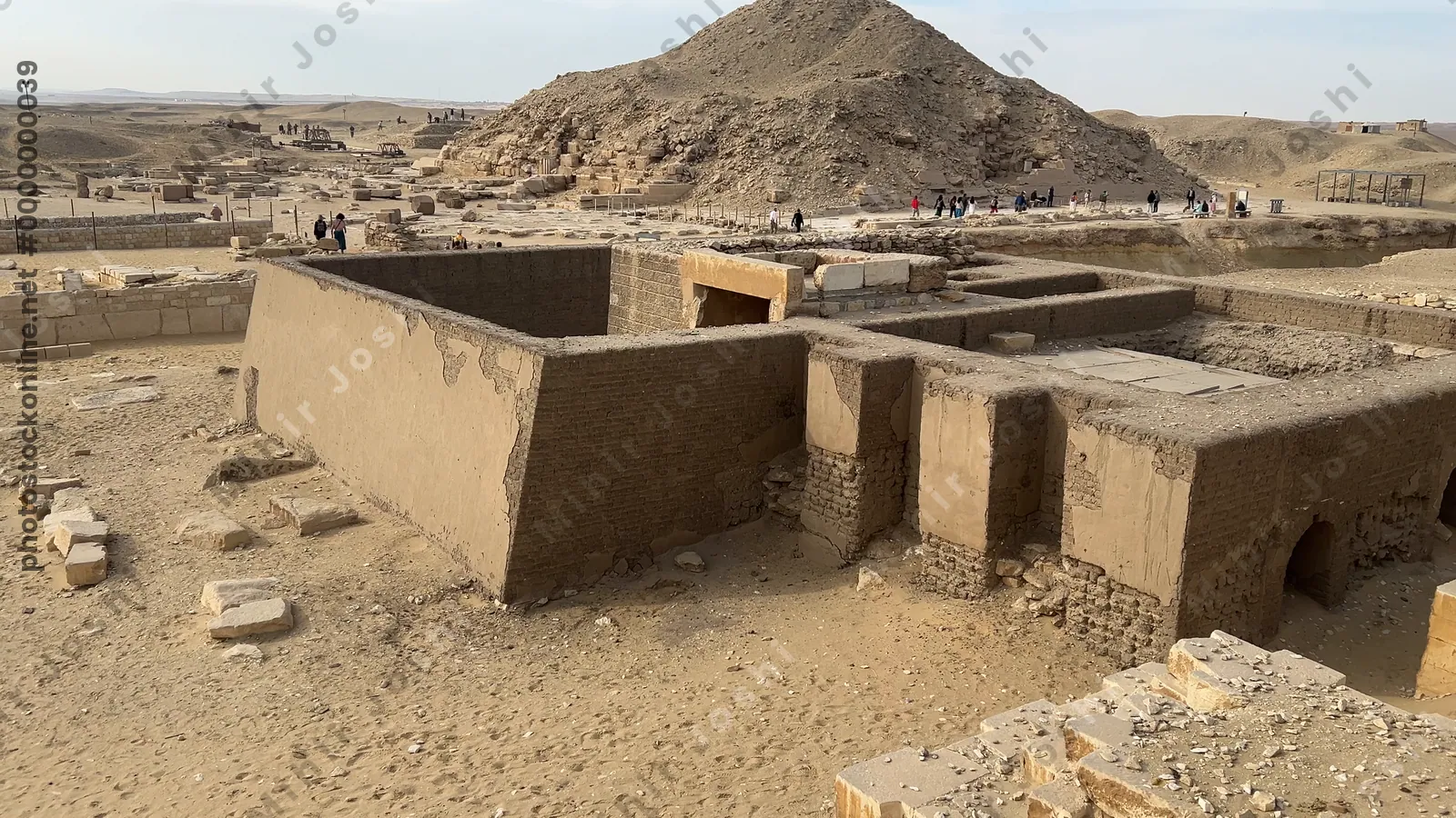 Saqqara, Egypt - Feb 5, 2024: Ancient Egyptian mastaba tomb in Saqqara Necropolis with the Pyramid of Unas visible in the background.