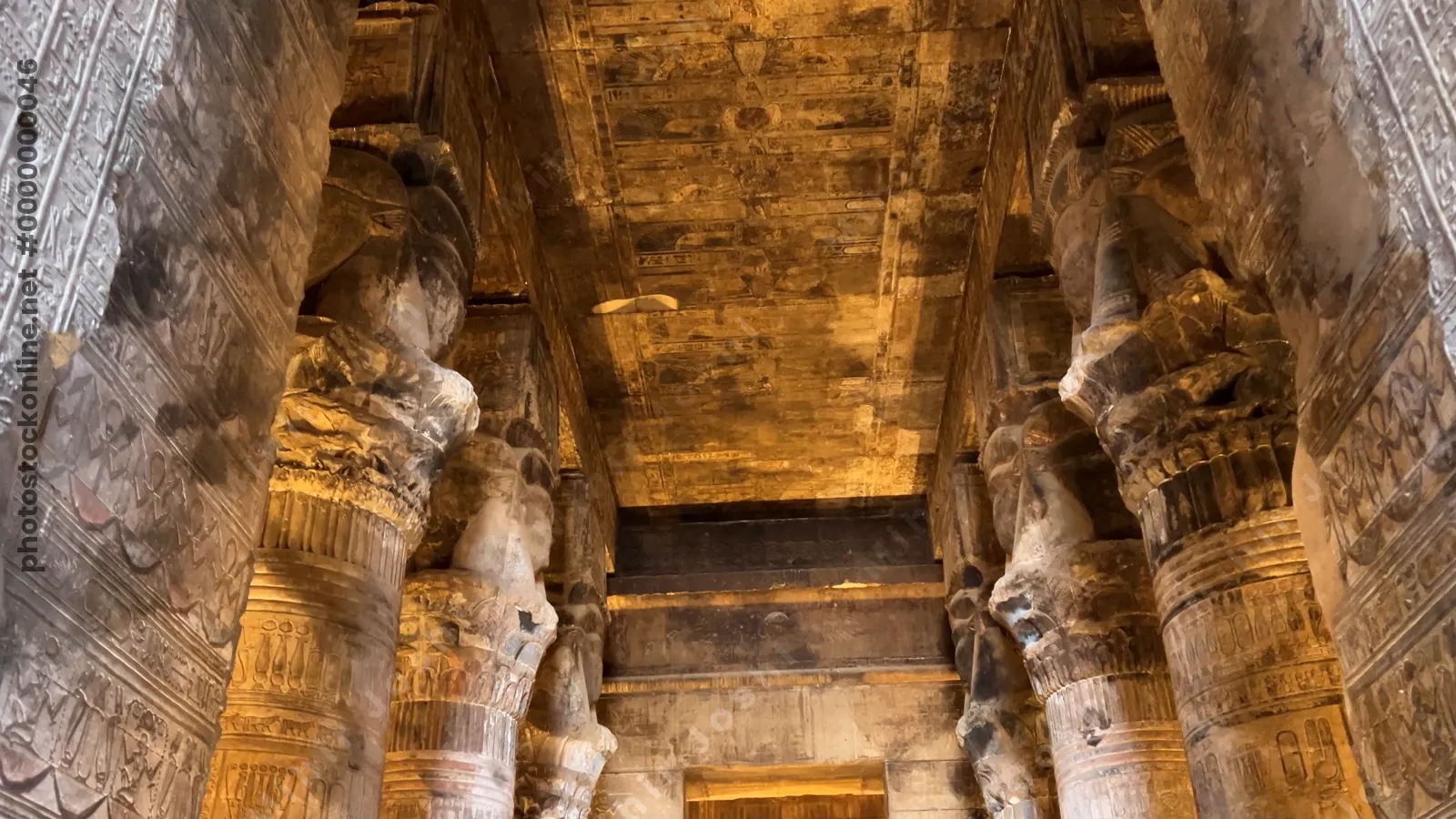 Walking among tall columns inside the Temple of Dendera, Egypt