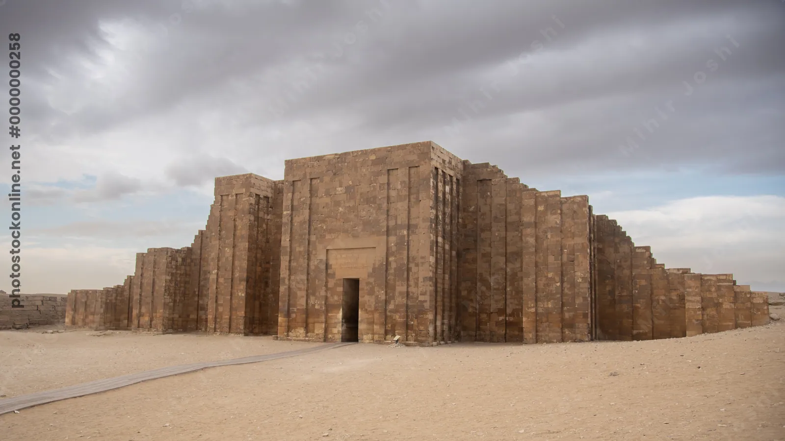 Massive limestone enclosure wall of the Step Pyramid complex at Saqqara, part of the ancient necropolis near Memphis, Egypt.