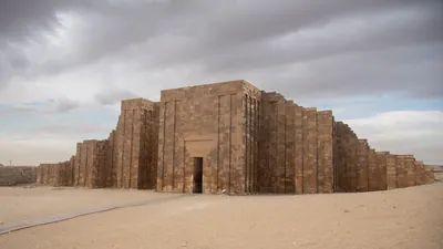 Massive limestone enclosure wall of the Step Pyramid complex at Saqqara, part of the ancient necropolis near Memphis, Egypt.