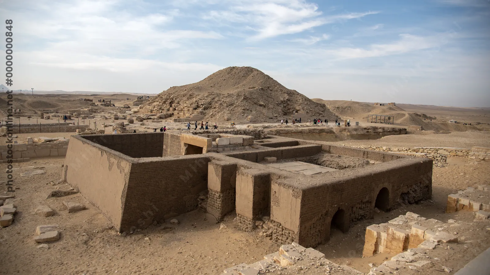Saqqara, Egypt - Feb 5, 2024: Ancient Egyptian mastaba tomb in Saqqara Necropolis with the Pyramid of Unas visible in the background.