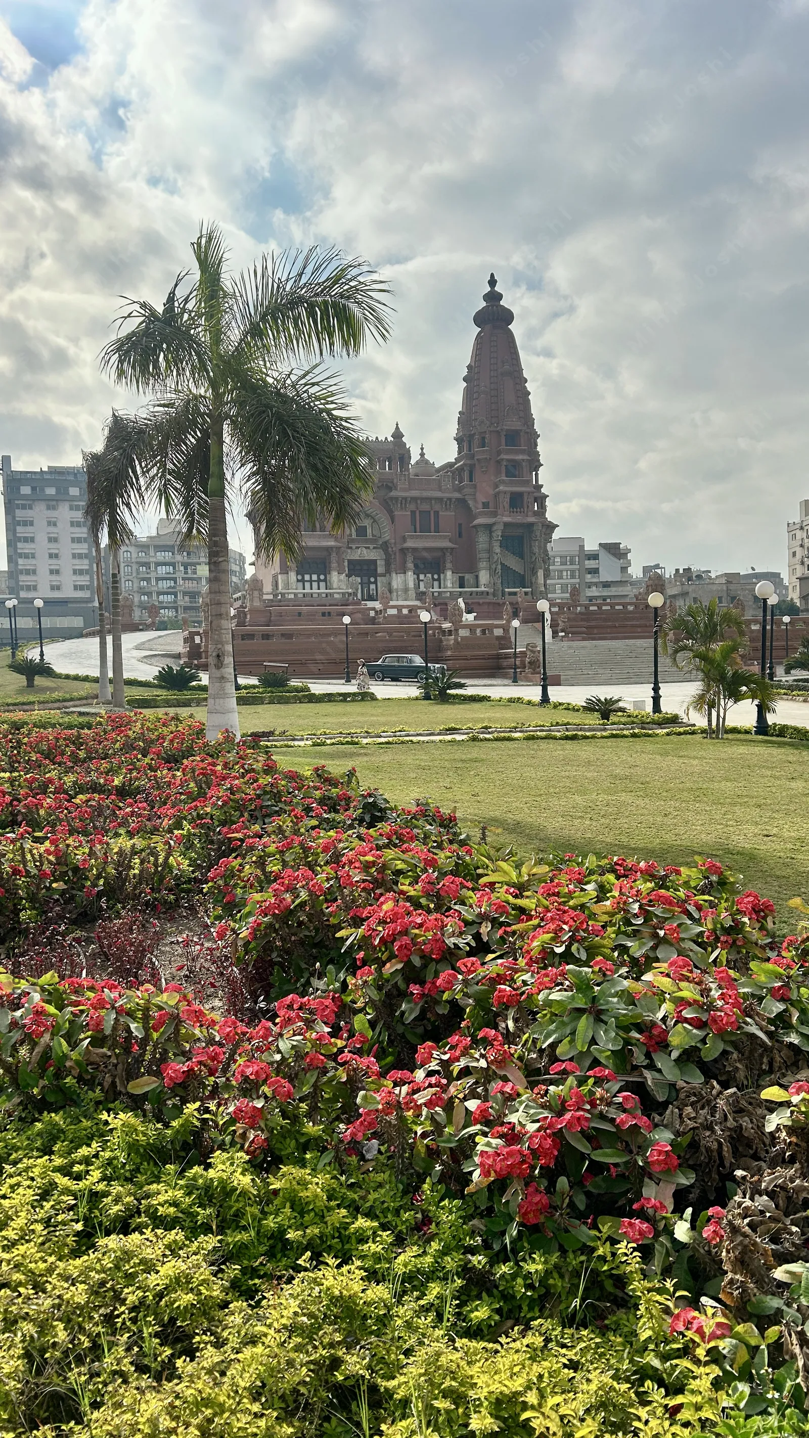 Heliopolis, Cairo, Egypt - Feb 4, 2024: Lush garden with the historic Baron Empain Palace in the background, a Hindu-style mansion in Heliopolis, Cairo
