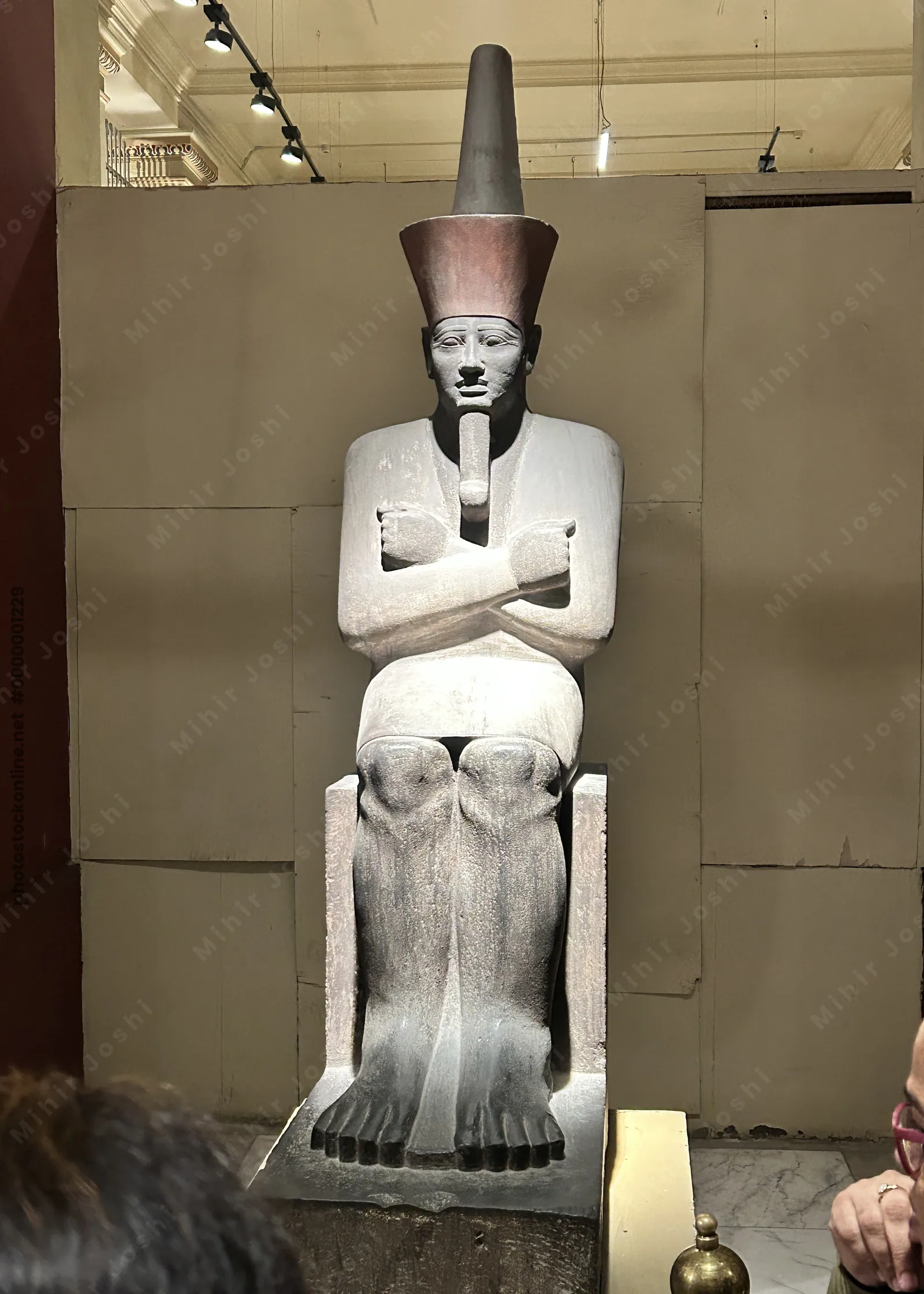 Cairo, Egypt - Feb 4, 2025: Seated statue of Pharaoh Nebhepetre Mentuhotep II, reunifier of Egypt, on display at the Egyptian Museum in Cairo.