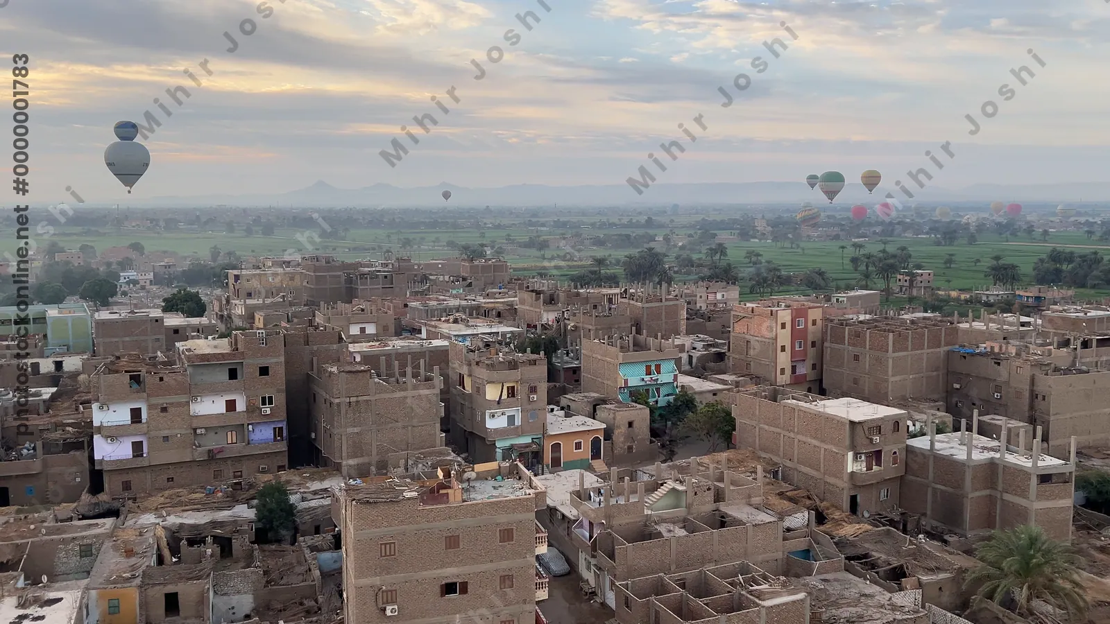 Hot air balloons floating above Luxor town and fa