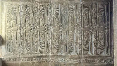 Detailed carvings of vultures, symbols of the god
