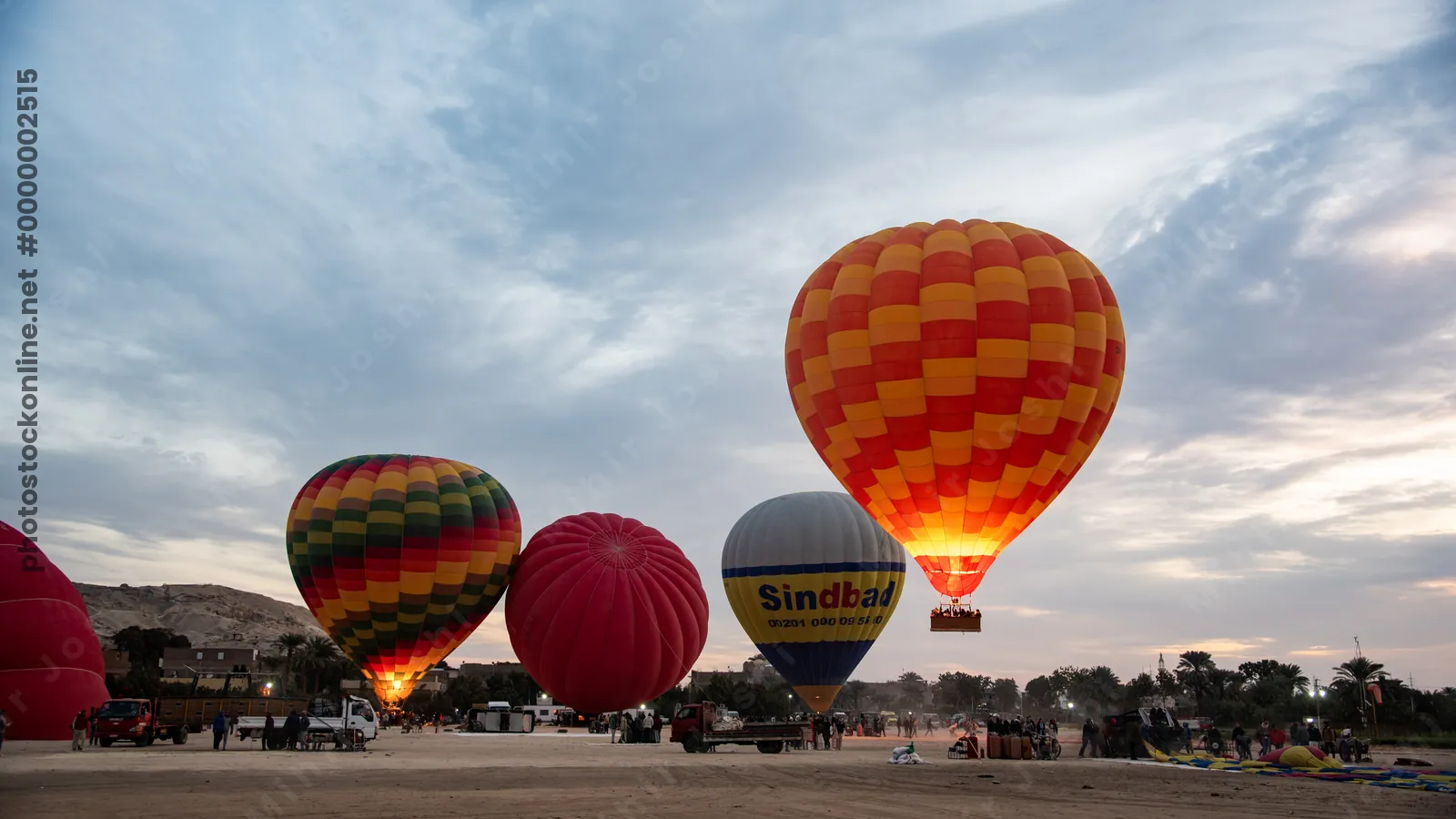 Colorful hot air balloons prepare for sunrise fli
