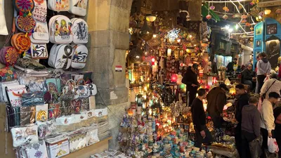 Cairo, Egypt - Feb 12, 2025: Brightly lit lamps and lanterns displayed in the bustling street market of Khan el-Khalili, the famous bazaar in historic Cairo.