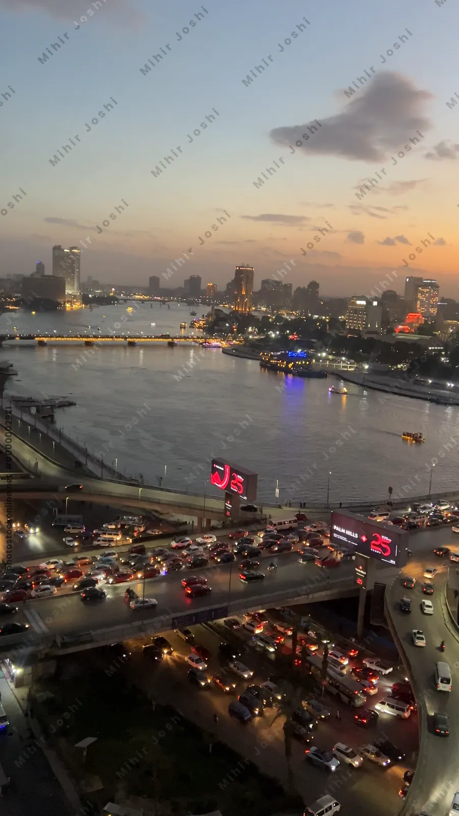 Cairo, Egypt - Feb 5, 2024: Aerial footage of Cairo, Egypt in early evening showing dense traffic, warm city tones, and the bustling movement of a typical rush hour.