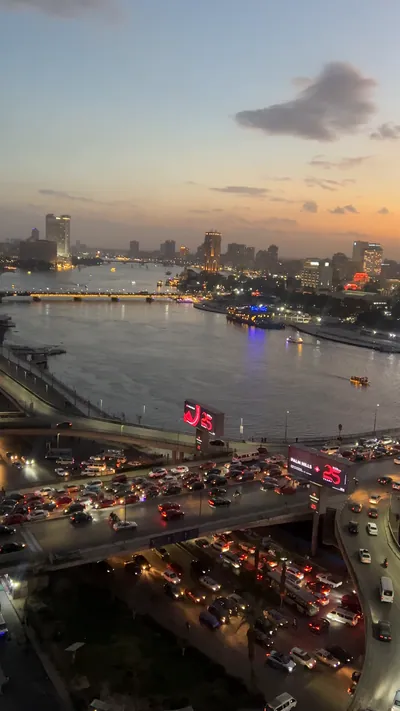 Cairo, Egypt - Feb 5, 2024: Aerial footage of Cairo, Egypt in early evening showing dense traffic, warm city tones, and the bustling movement of a typical rush hour.