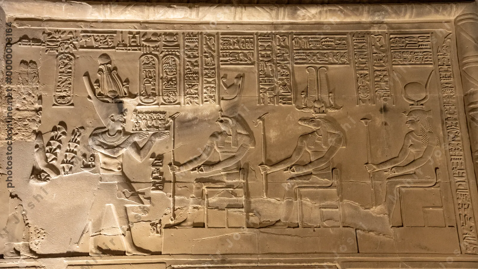 Wall relief at Kom Ombo shows Pharaoh worshipping Horus, Sobek, and Hathor.