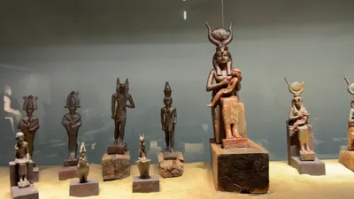 Saqqara, Egypt - Feb 5, 2024: artistry of ancient Egypt with statues of various gods including Osiris, Anubis, Sekhmet, and Isis with Child Horus at the Imhotep Museum in Saqqara.