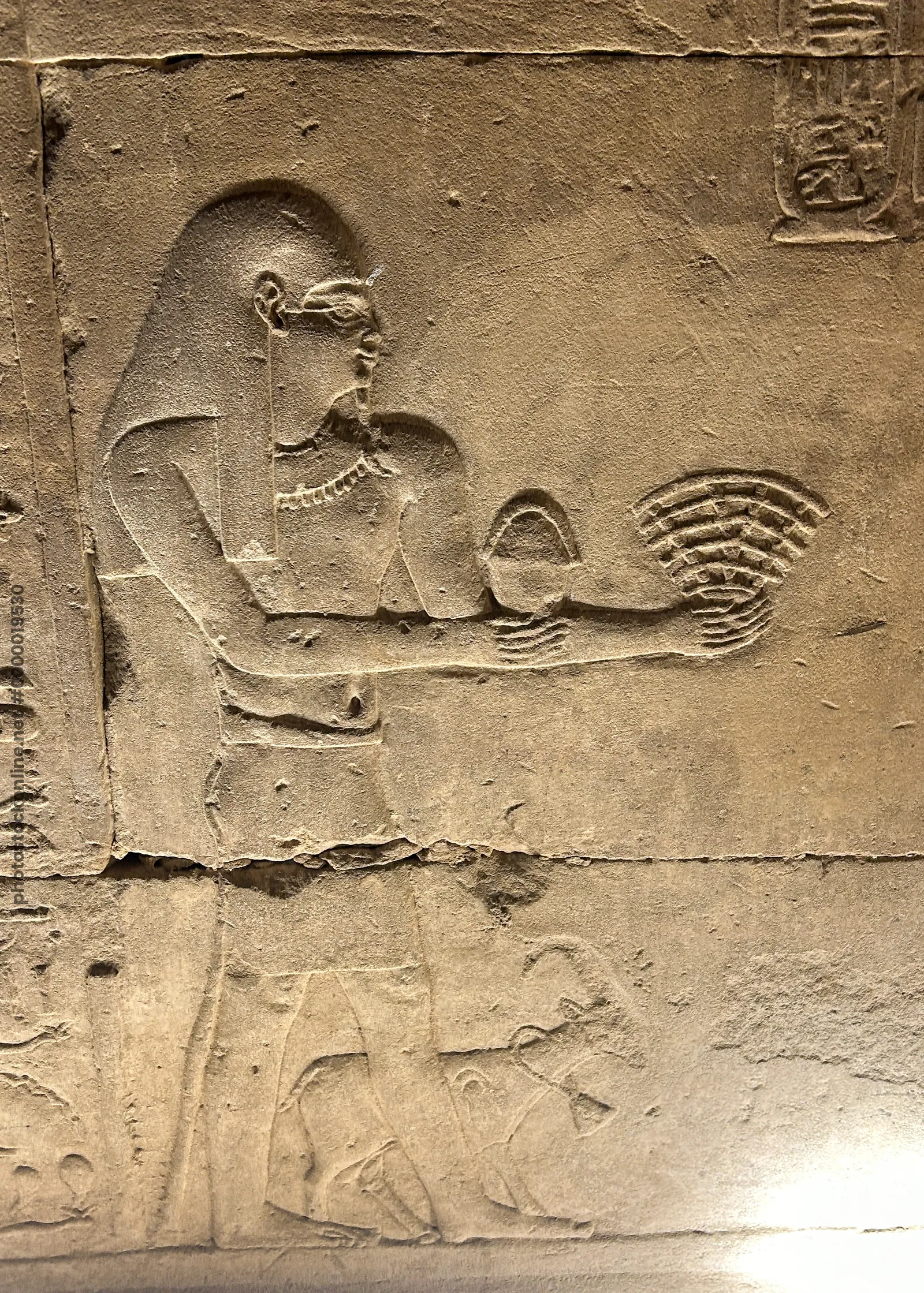 Edfu, Egypt - Feb 9, 2025: Ancient Egyptian relief at the Temple of Horus depicting a ritual fan-shaped offering, popularly nicknamed the Wi-Fi logo relief.