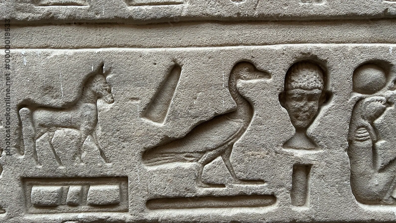Edfu, Egypt - Feb 9, 2025: Close-up of ancient Egyptian hieroglyphs at the Temple of Horus in Edfu, depicting carved animals and human figures in stone.