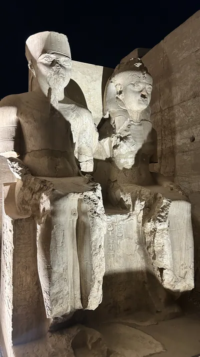 Luxor, Egypt - Feb 9, 2025: Illuminated double statue of the gods Amun and Mut with the facial features of Tutankhamun and Ankhesenamun, located at Luxor Temple in Egypt.