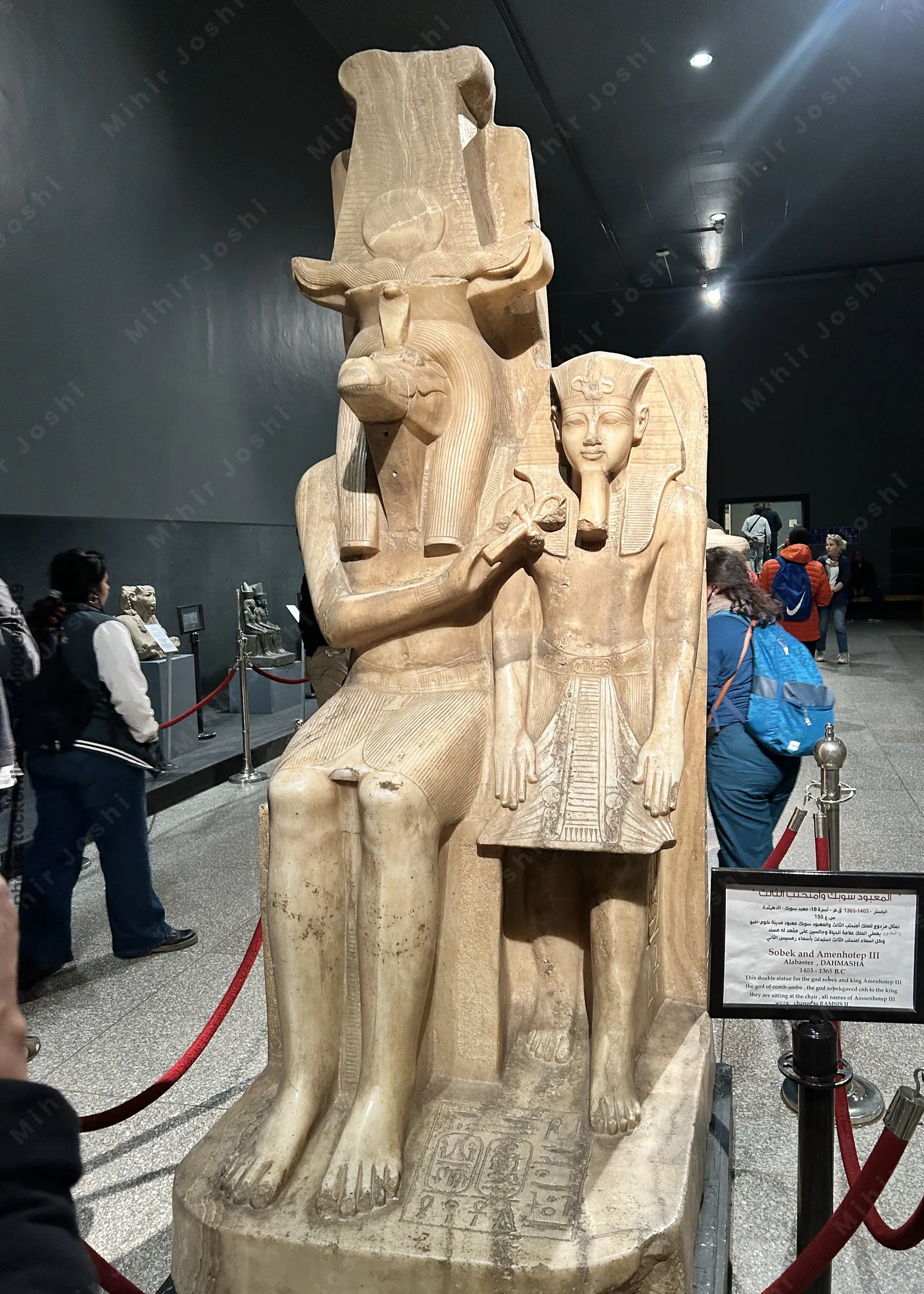 Luxor, Egypt - Feb 9, 2025: Alabaster double statue of the crocodile-headed god Sobek and Pharaoh Amenhotep III from ancient Egypt, displayed at the Luxor Museum.