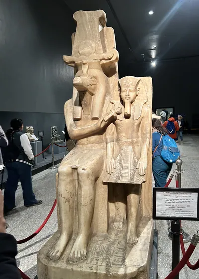 Luxor, Egypt - Feb 9, 2025: Alabaster double statue of the crocodile-headed god Sobek and Pharaoh Amenhotep III from ancient Egypt, displayed at the Luxor Museum.