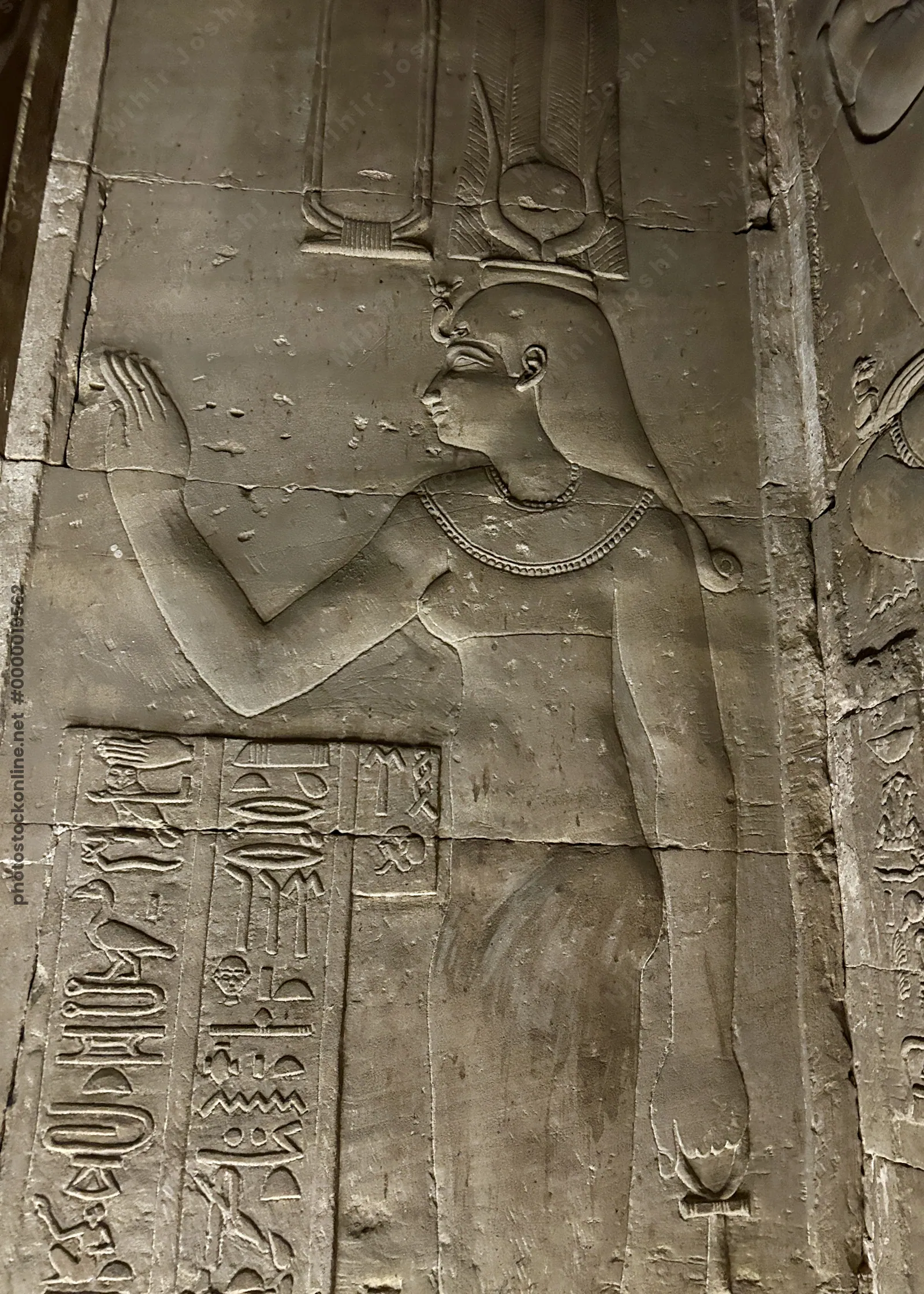 Dendera, Egypt - Feb 10, 2025: Ancient wall relief of a goddess figure with hieroglyphic inscriptions inside the Temple of Hathor at Dendera, Egypt.