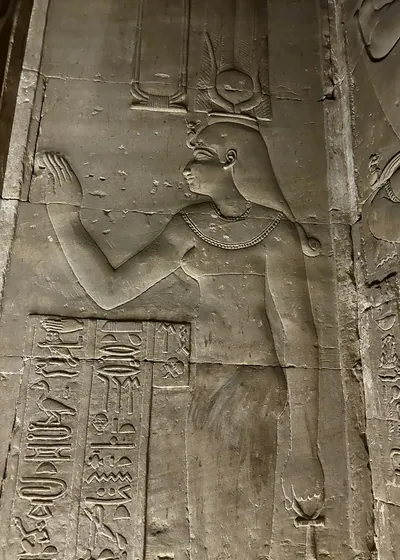 Dendera, Egypt - Feb 10, 2025: Ancient wall relief of a goddess figure with hieroglyphic inscriptions inside the Temple of Hathor at Dendera, Egypt.
