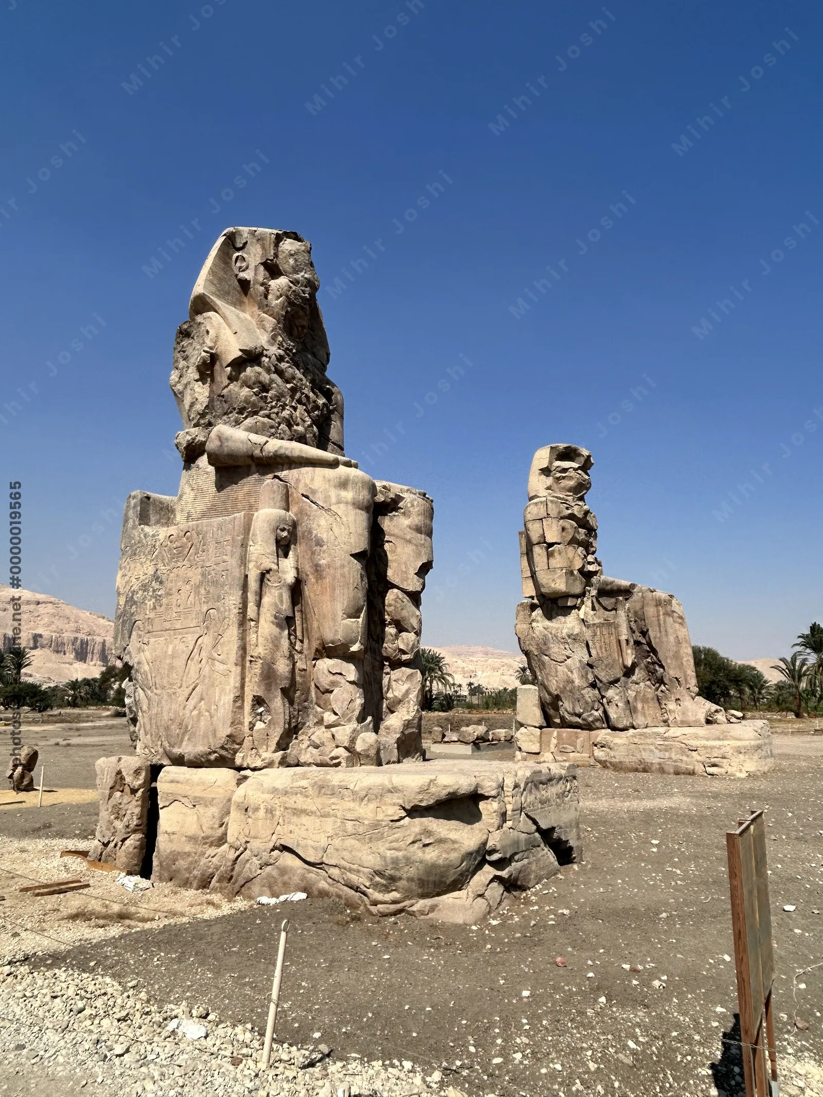 Luxor, Egypt - Feb 11, 2025: The Colossi of Memnon, two massive seated statues of Pharaoh Amenhotep III, located on the west bank of the Nile near Luxor, Egypt.