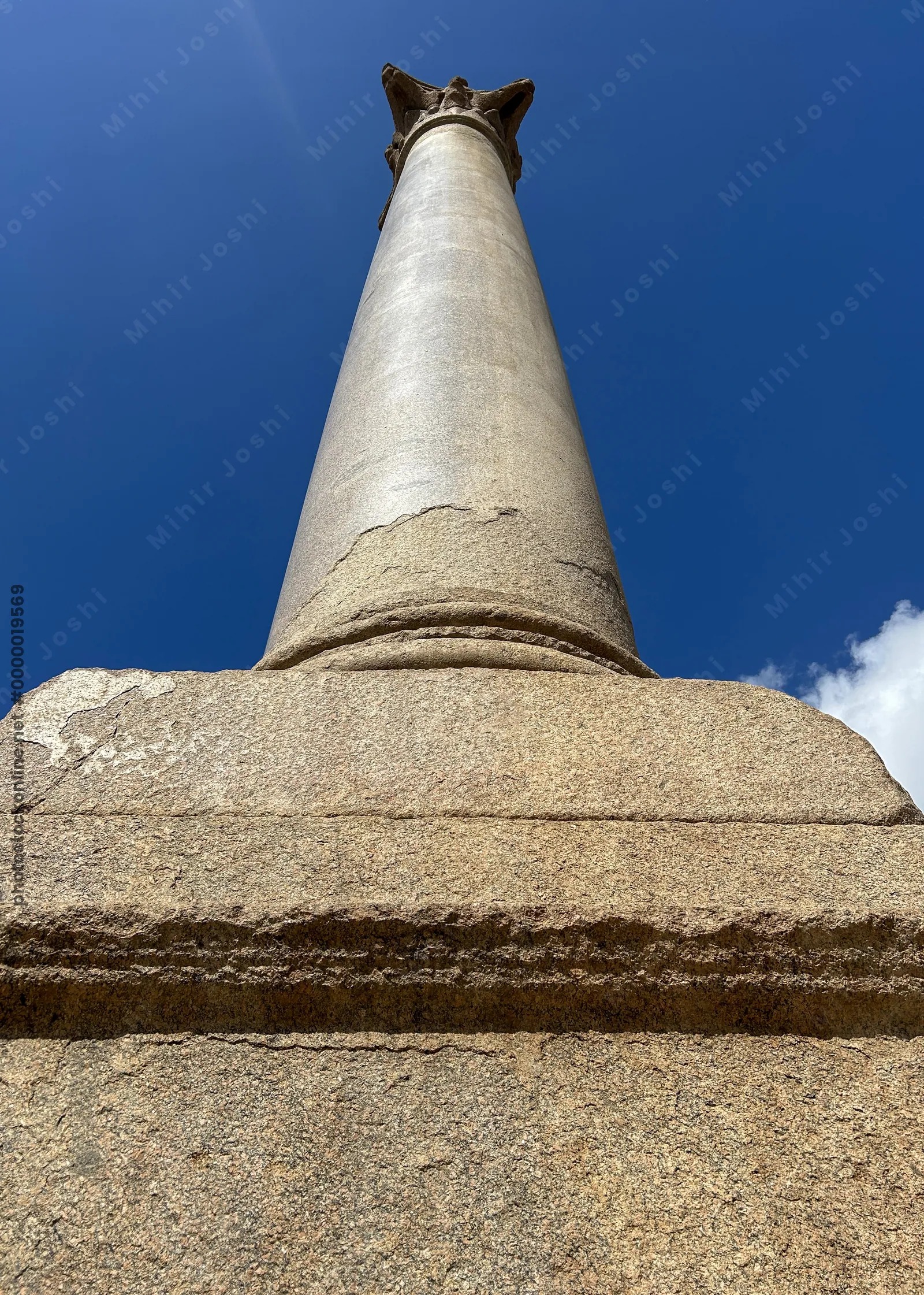 Alexandria, Egypt - Feb 13, 2025: Granite Roman triumphal column known as Pompeys Pillar standing at the ancient Serapeum of Alexandria in Egypt.