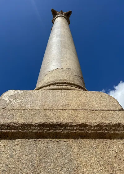Alexandria, Egypt - Feb 13, 2025: Granite Roman triumphal column known as Pompeys Pillar standing at the ancient Serapeum of Alexandria in Egypt.