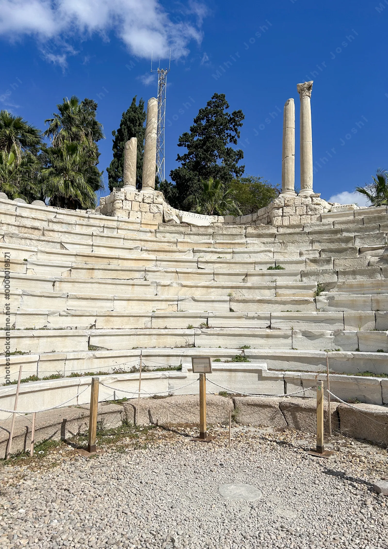 Alexandria, Egypt - Feb 13, 2025: Ancient Roman Amphitheatre with stone seating rows and standing columns at the archaeological site of Kom El-Dikka.