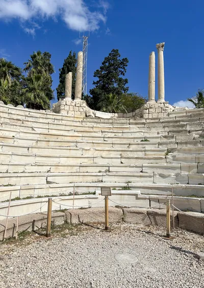 Alexandria, Egypt - Feb 13, 2025: Ancient Roman Amphitheatre with stone seating rows and standing columns at the archaeological site of Kom El-Dikka.