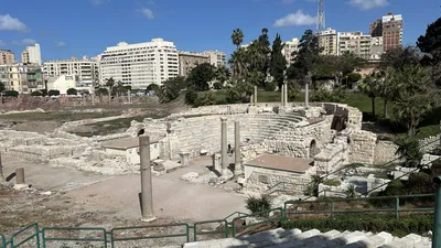 Alexandria, Egypt - Feb 13, 2025: The Roman Amphitheatre in Alexandria, an ancient Greco-Roman landmark featuring marble seating, columns, and ruins,