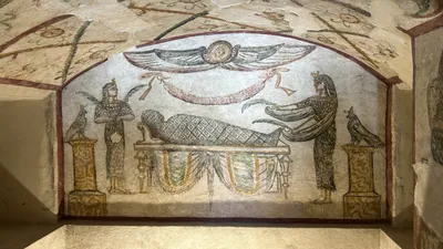 Alexandria, Egypt - Feb 13, 2025: Fresco showing goddess Isis assisting in the embalming of a mummy inside the Tomb of Tigran at the Catacombs of Kom