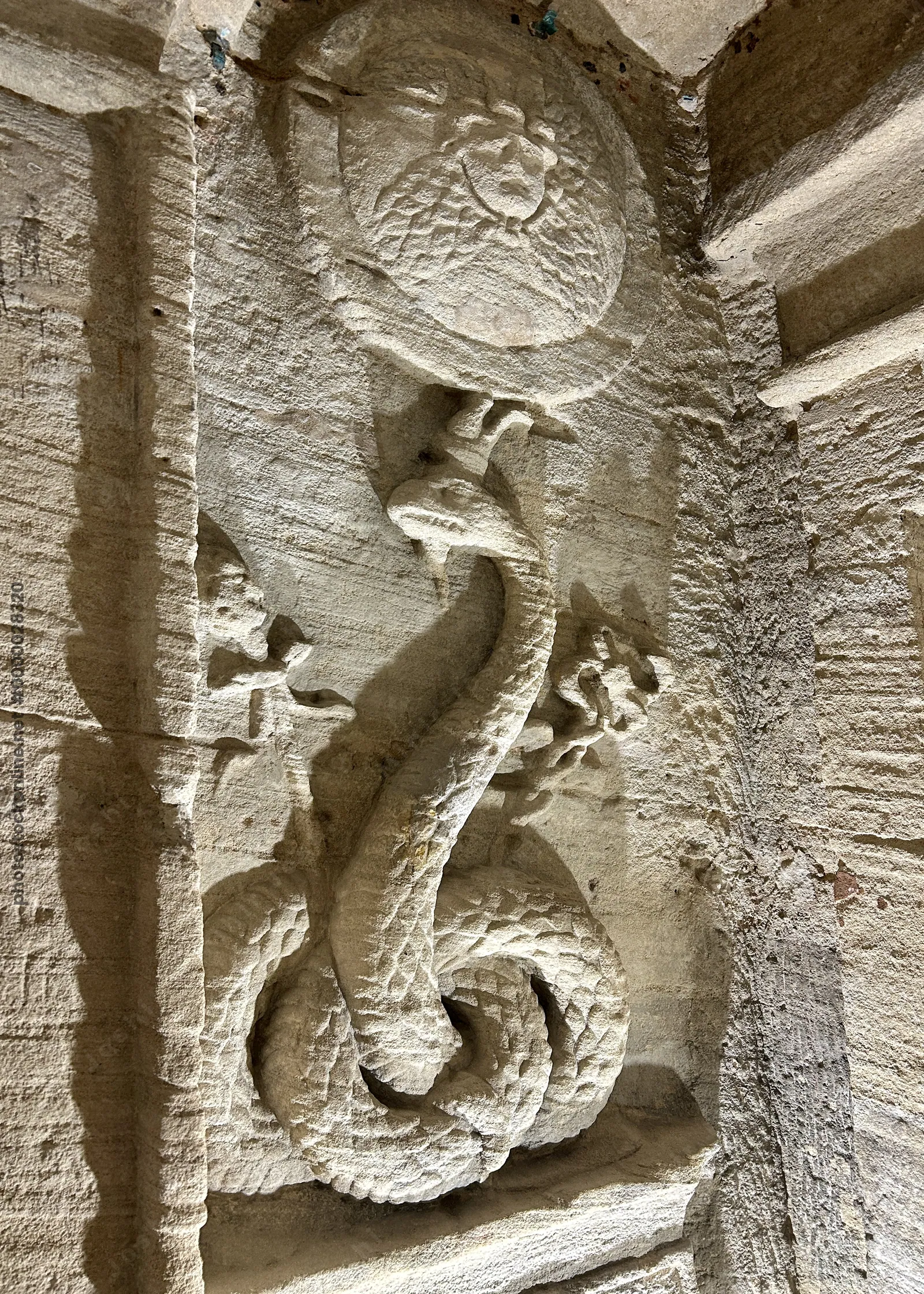 Alexandria, Egypt - Feb 12, 2025: Stone carving depicting the Agathos Daimon serpent at the Catacombs of Kom El Shoqafa, a Greco-Roman necropolis in A