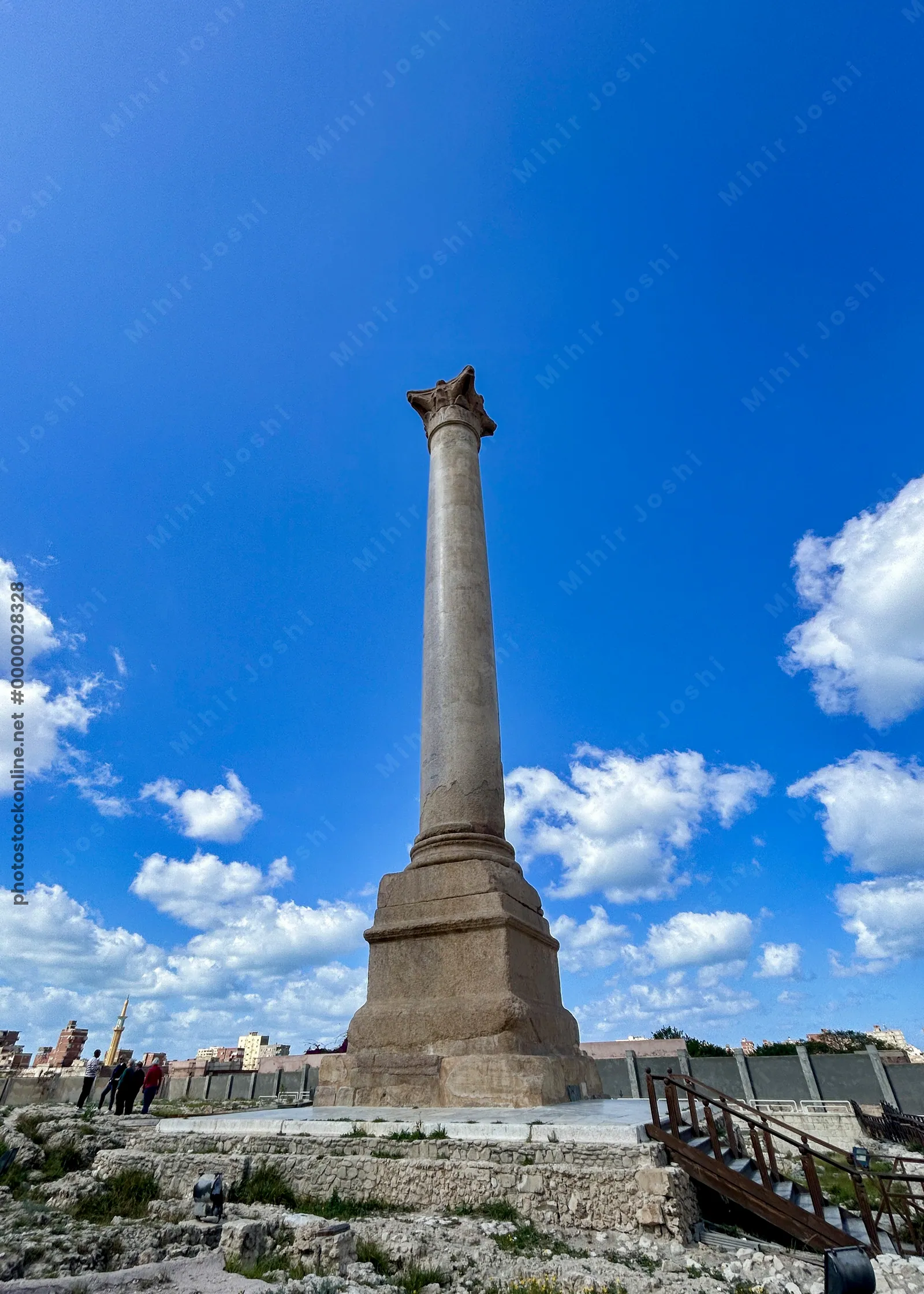 Alexandria, Egypt - Feb 13, 2025: Granite Roman triumphal column known as Pompey's Pillar standing at the ancient Serapeum of Alexandria in Egypt.
