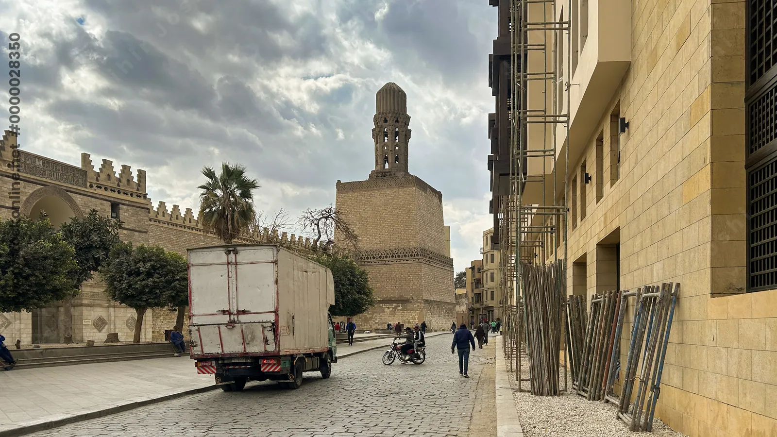 Al-Hakim Mosque minaret and street scene in Cairo, Egypt