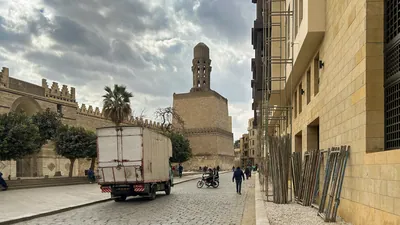 Al-Hakim Mosque minaret and street scene in Cairo, Egypt