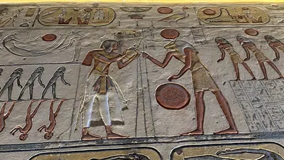 Valley of the Kings, Egypt - Feb 11, 2025: Painted relief from the Amduat showing deities, figures, and symbols in the Tomb of Ramesses IX (KV6).