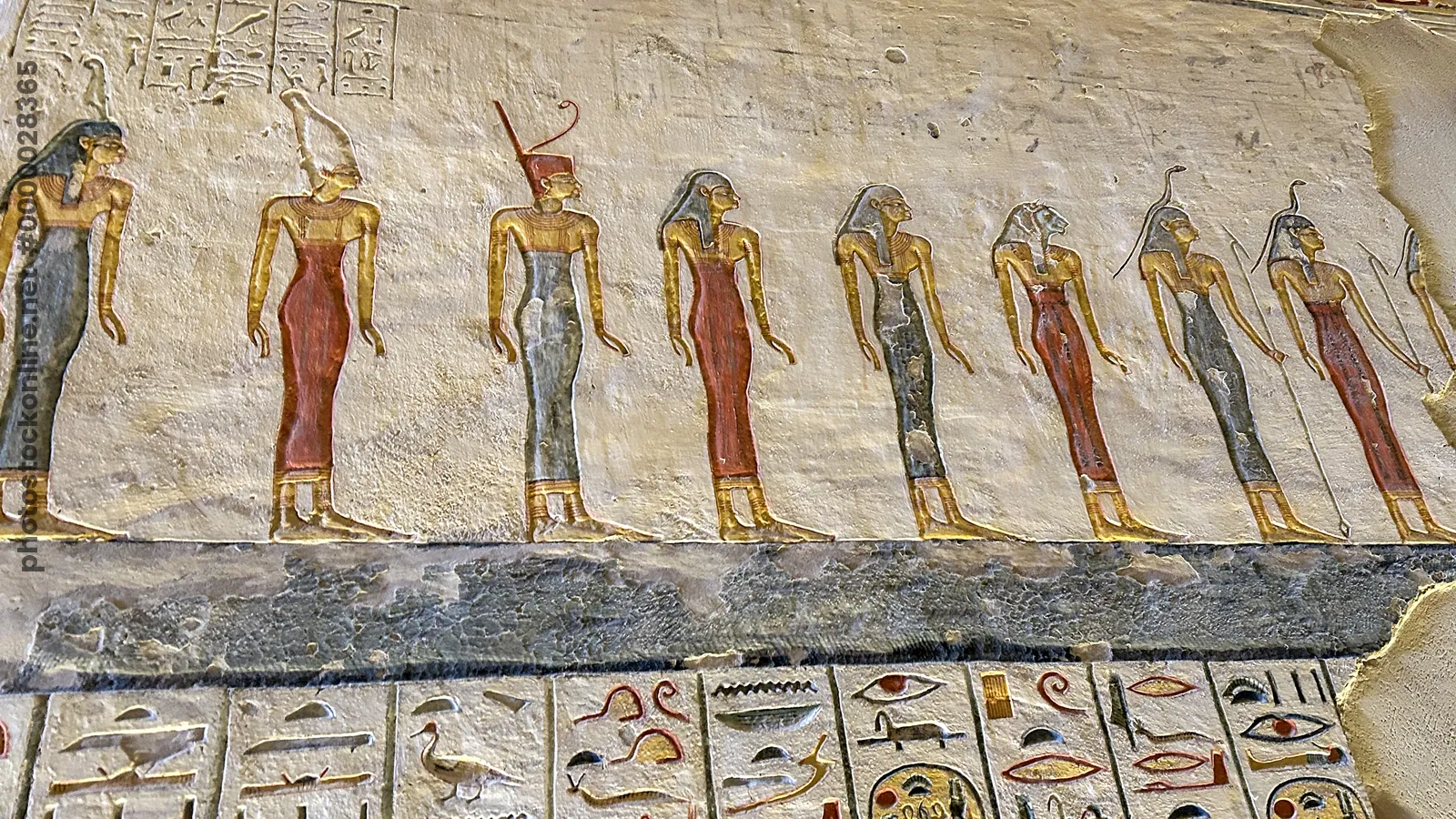 Valley of the Kings, Egypt - Feb 11, 2025: Painted relief showing a row of standing figures with hieroglyphics in the Tomb of Ramesses IX (KV6).