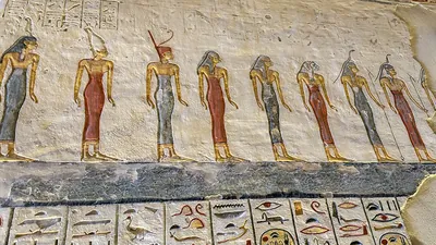 Valley of the Kings, Egypt - Feb 11, 2025: Painted relief showing a row of standing figures with hieroglyphics in the Tomb of Ramesses IX (KV6).