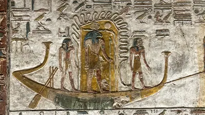 Valley of the Kings, Egypt - Feb 11, 2025: Painted relief from the fifth hour of the Book of Gates with figures and solar barque in Tomb KV17.