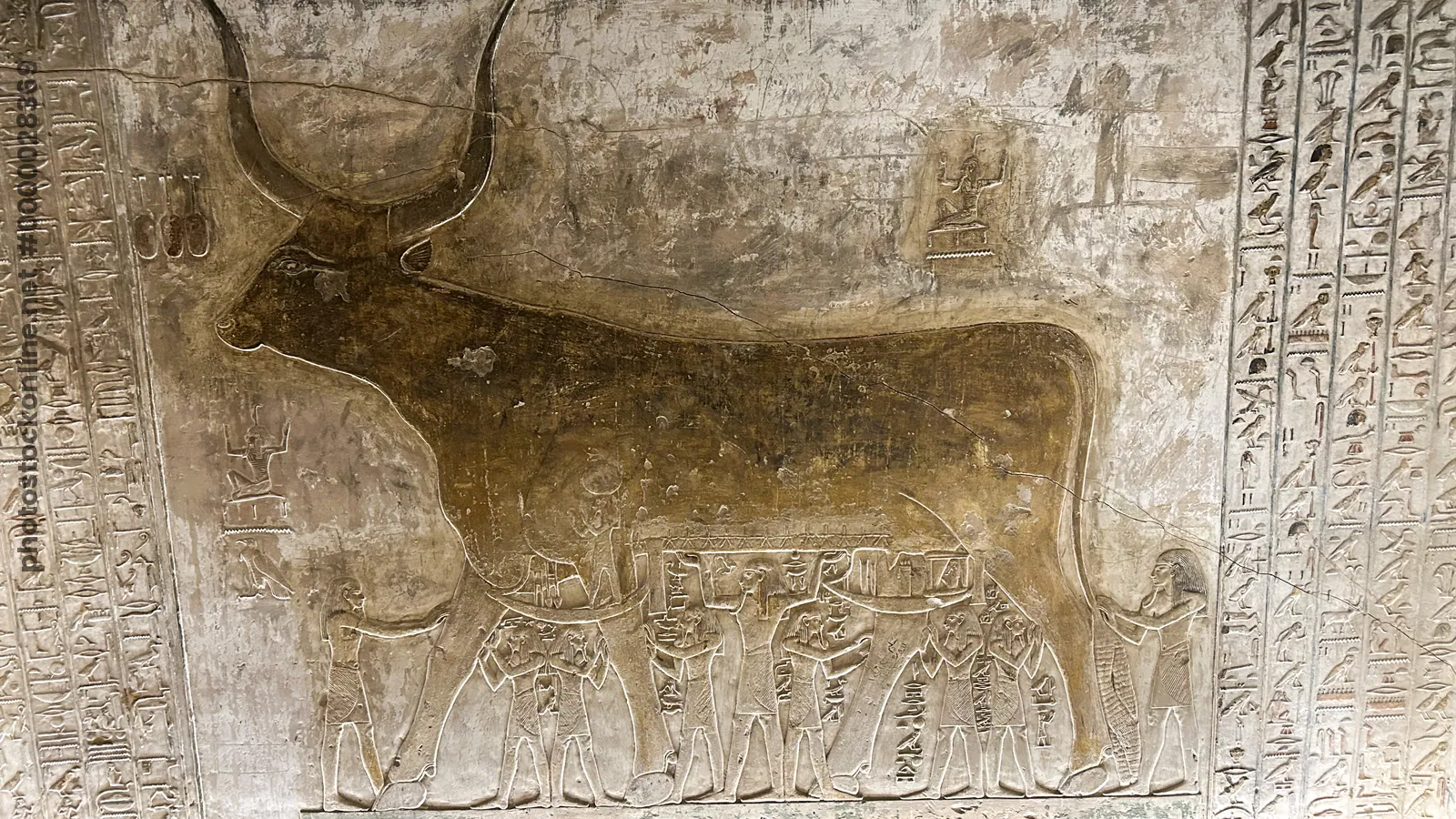 Valley of the Kings, Egypt - Feb 11, 2025: Painted relief of the Book of the Heavenly Cow with bovine figure and attendants in the Tomb of Seti I (KV1