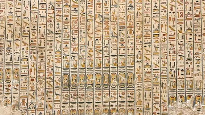 Luxor, Egypt - Feb 11, 2025: Ancient hieroglyphic inscriptions carved and painted on a wall inside a royal tomb at the Valley of the Kings.