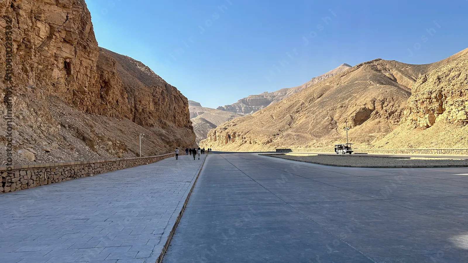 Luxor, Egypt - Feb 11, 2025: Entrance road at the Valley of the Kings, showing the pathway and transport area leading into the ancient royal necropoli