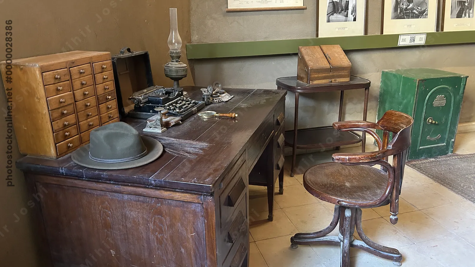 Luxor, Egypt - Feb 11, 2025: Study interior at Howard Carter House, showing wooden desk with typewriter, magnifying glass, oil lamp, chair, and safe.