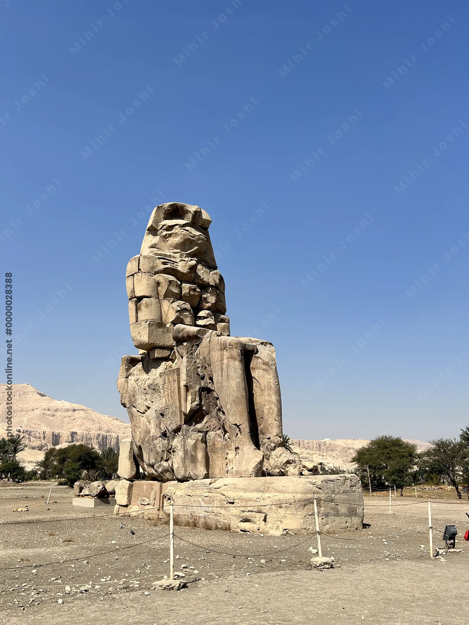 Luxor, Egypt - Feb 11, 2025: The Colossi of Memnon, two massive seated statues of Pharaoh Amenhotep III, located on the west bank of the Nile near Lux
