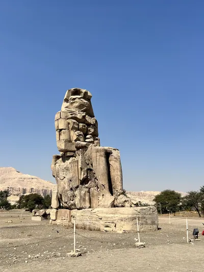 Luxor, Egypt - Feb 11, 2025: The Colossi of Memnon, two massive seated statues of Pharaoh Amenhotep III, located on the west bank of the Nile near Lux