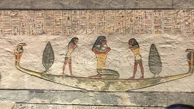 Luxor, Egypt - Feb 11, 2025: Ancient painted wall relief from the Tomb of Ramesses IV showing a divine bark with standing and kneeling figures, surrou