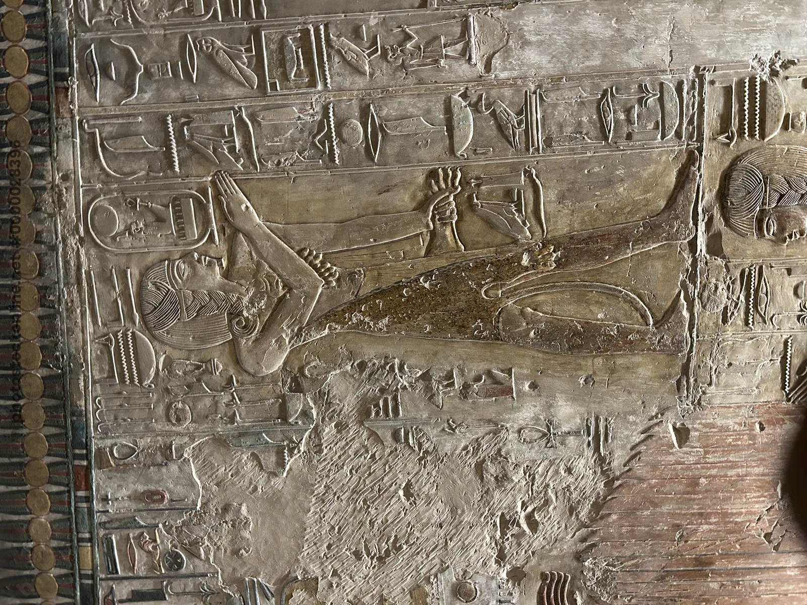 Luxor, Egypt - Feb 11, 2025: Ancient wall relief from KV17, the Tomb of Seti I, depicting a pharaoh with cartouches and hieroglyphic inscriptions in t