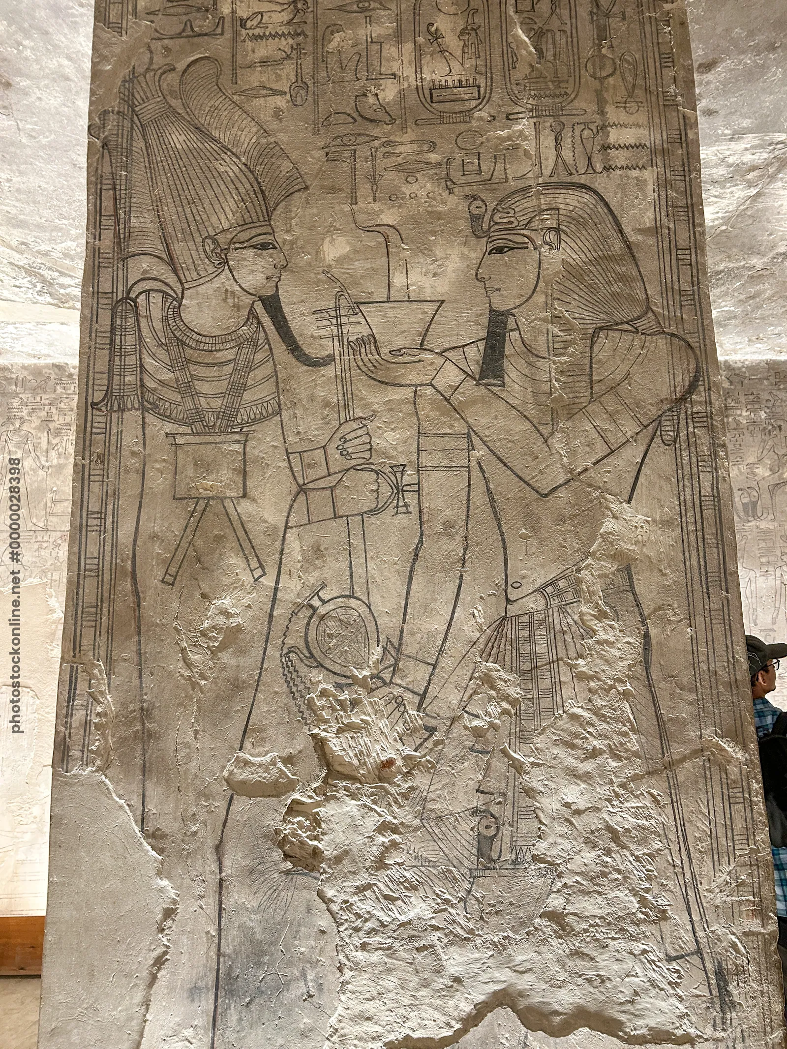 Luxor, Egypt - Feb 11, 2025: Unfinished wall relief from KV17, the Tomb of Seti I, depicting a king making an offering to a deity, drawn in outline wi