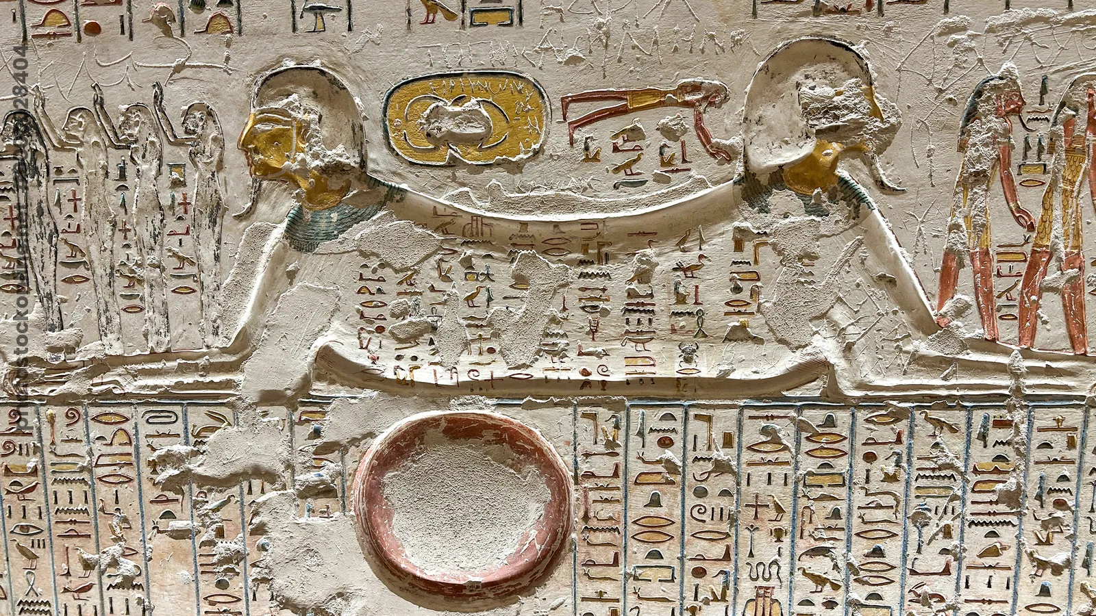 Luxor, Egypt - Feb 11, 2025: Ancient relief depicting Aker in the form of a double sphinx flanked by hieroglyphic inscriptions in a tomb at the Valley