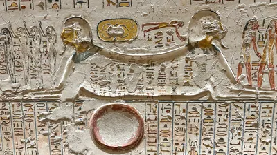 Luxor, Egypt - Feb 11, 2025: Ancient relief depicting Aker in the form of a double sphinx flanked by hieroglyphic inscriptions in a tomb at the Valley