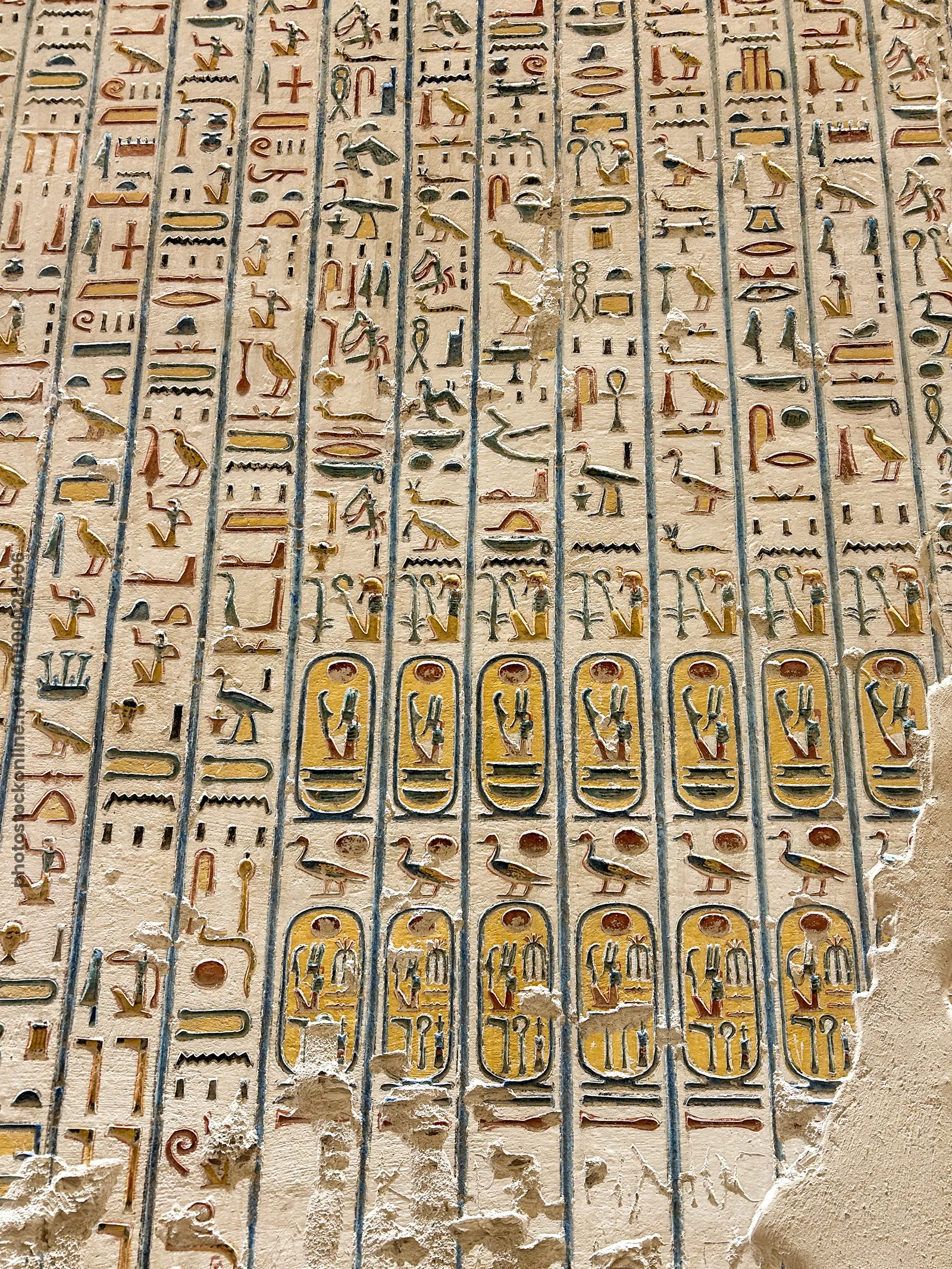 Luxor, Egypt - Feb 11, 2025: Ancient hieroglyphic wall inscriptions with royal cartouches preserved in a tomb at the Valley of the Kings, Egypt.