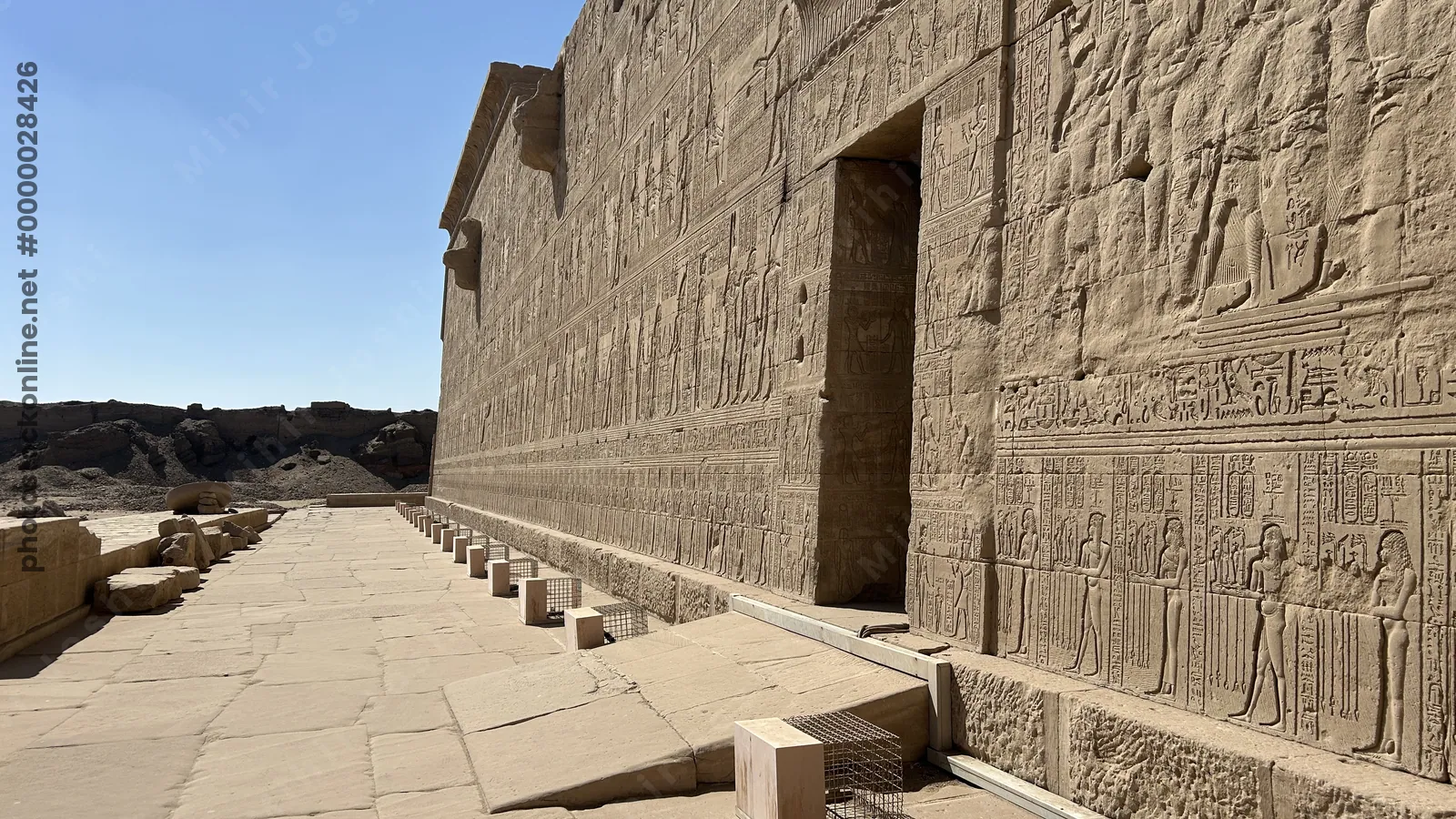Dendera, Egypt - Feb 10, 2025: Ancient stone reliefs and hieroglyphs carved into the outer wall of the Dendera Temple complex in Egypt.